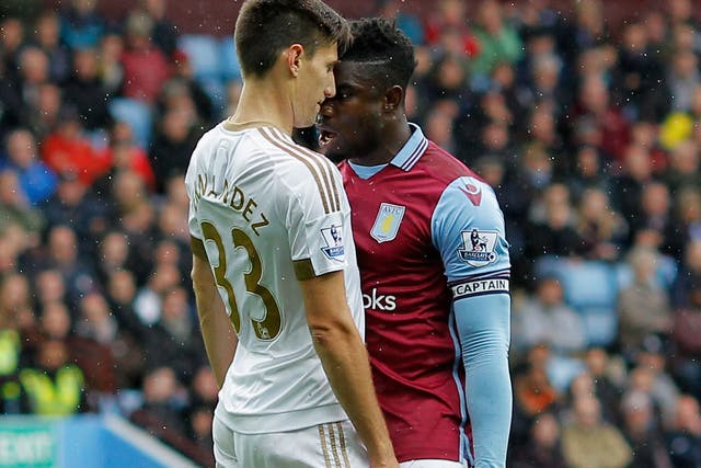 Aston Villa centre-back Micah Richards clashing with Swansea City's Federico Fernandez during the match on Saturday