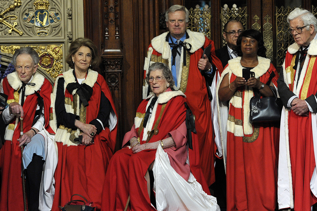 Peers look on as Yeomen of the Guard prepare to conduct the ceremonial search ahead of the State Opening of Parliament at the Palace of Westminster on June 4, 2014 in London