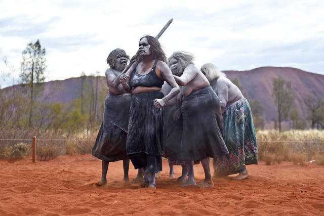 Aboriginal women perform traditional dances near Uluru to mark the 30th anniversary of the rock being handed back
