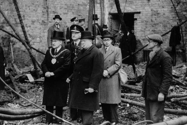 Prime Minister Winston Churchill inspecting the ruins of Manchester's Free Trade Hall after a bombing raid in WWII