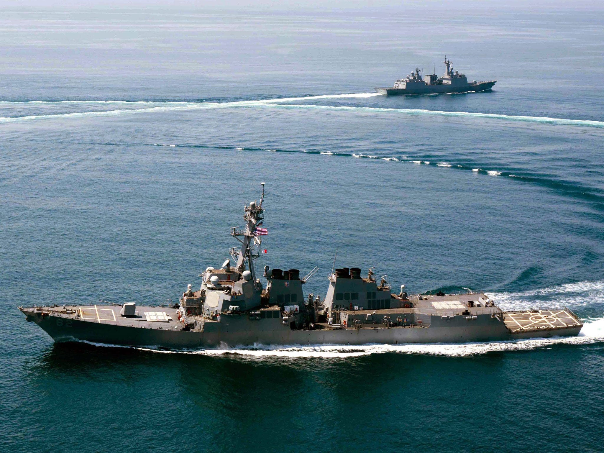 A handout photo released by the US Navy dated 25 May 2015 of the guided-missile destroyer USS Lassen (front) conducting a naval exercise off South Korea