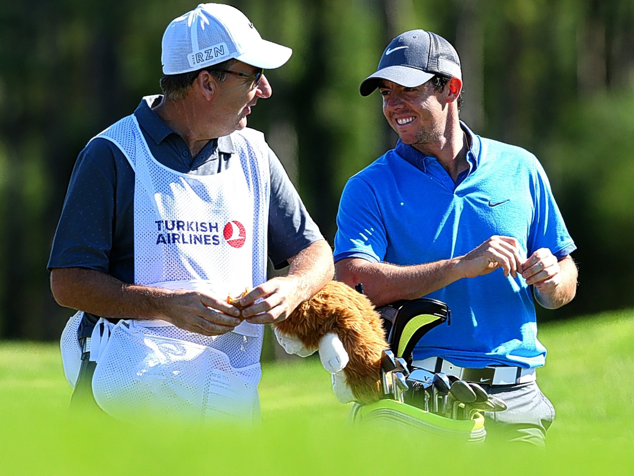 Rory McIlroy shares a joke with his caddie, JP Fitzgerald, during practice for the Turkish Airlines Open