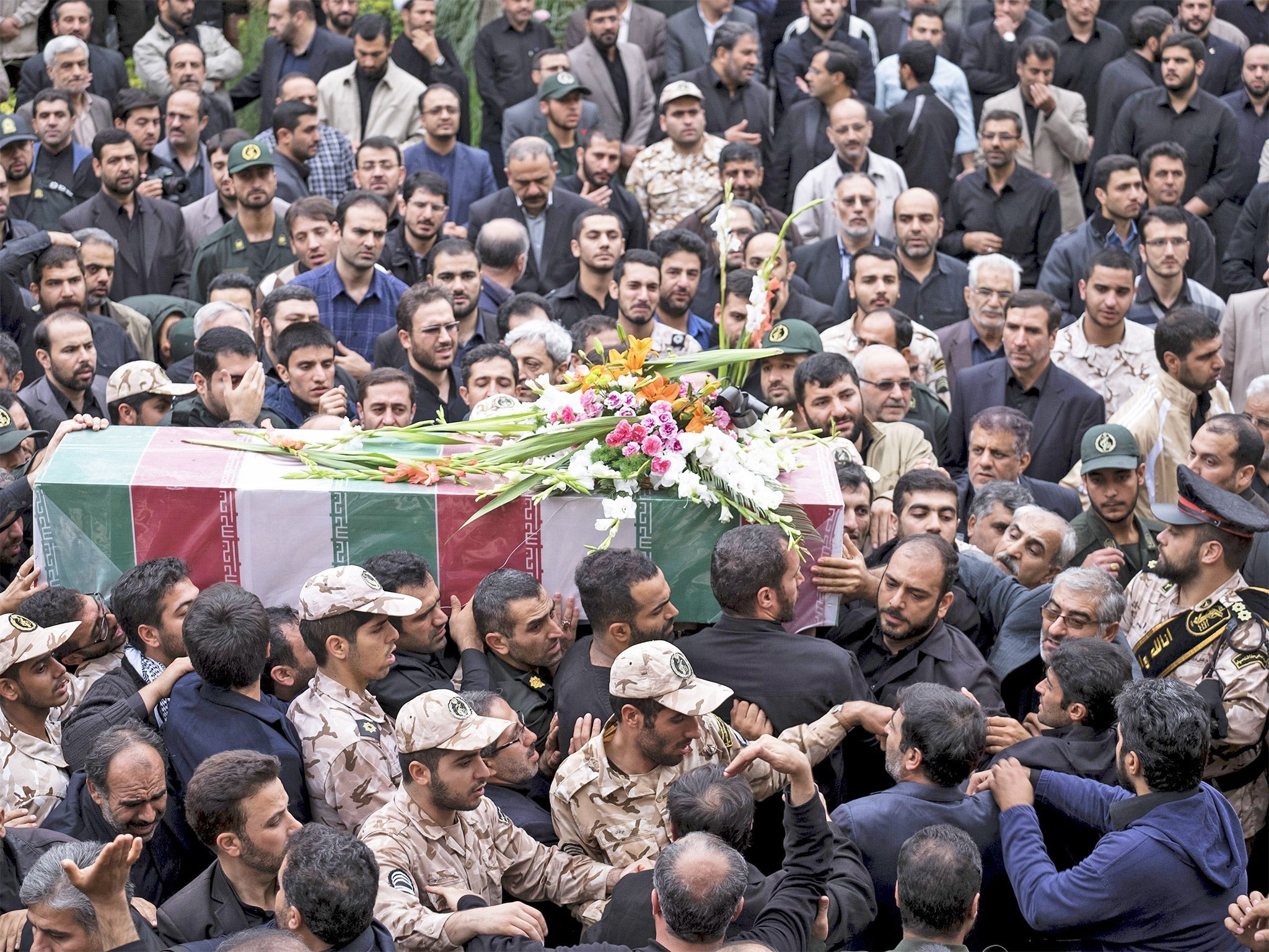 Mourners fill a Tehran street for the funeral of Abdollah Bagheri, a bodyguard of former Iranian President Mahmoud Ahmadinejad. Mr Bagheri was reportedly killed while guarding a shrine in Aleppo, Syria