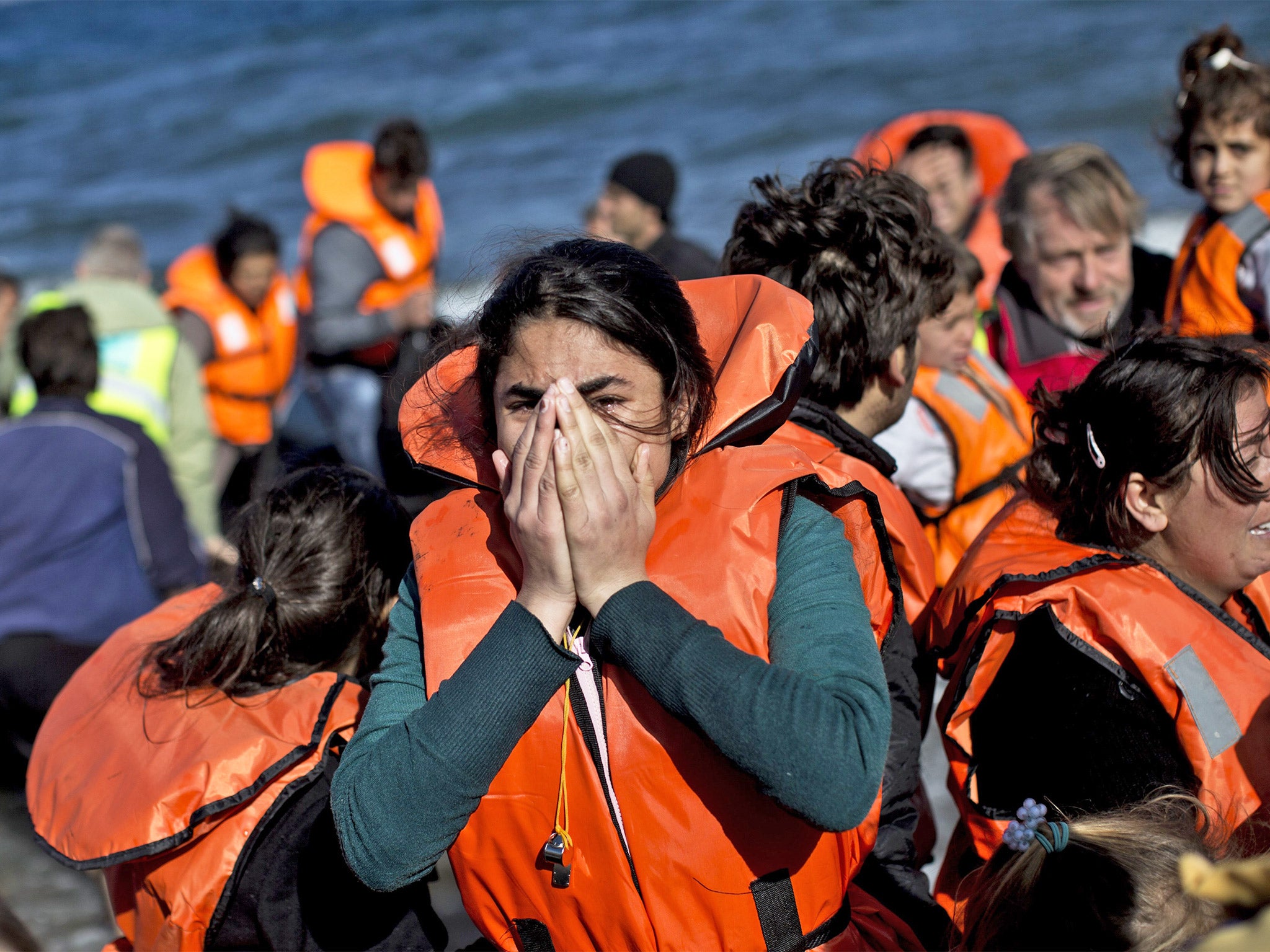 A woman reacts as she arrives, with other refugees, on the Greek island of Lesbos on Wednesday