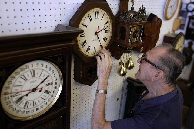 Howard Brown adjusts his clocks before Daylight Saving Time at his Florida clock shop