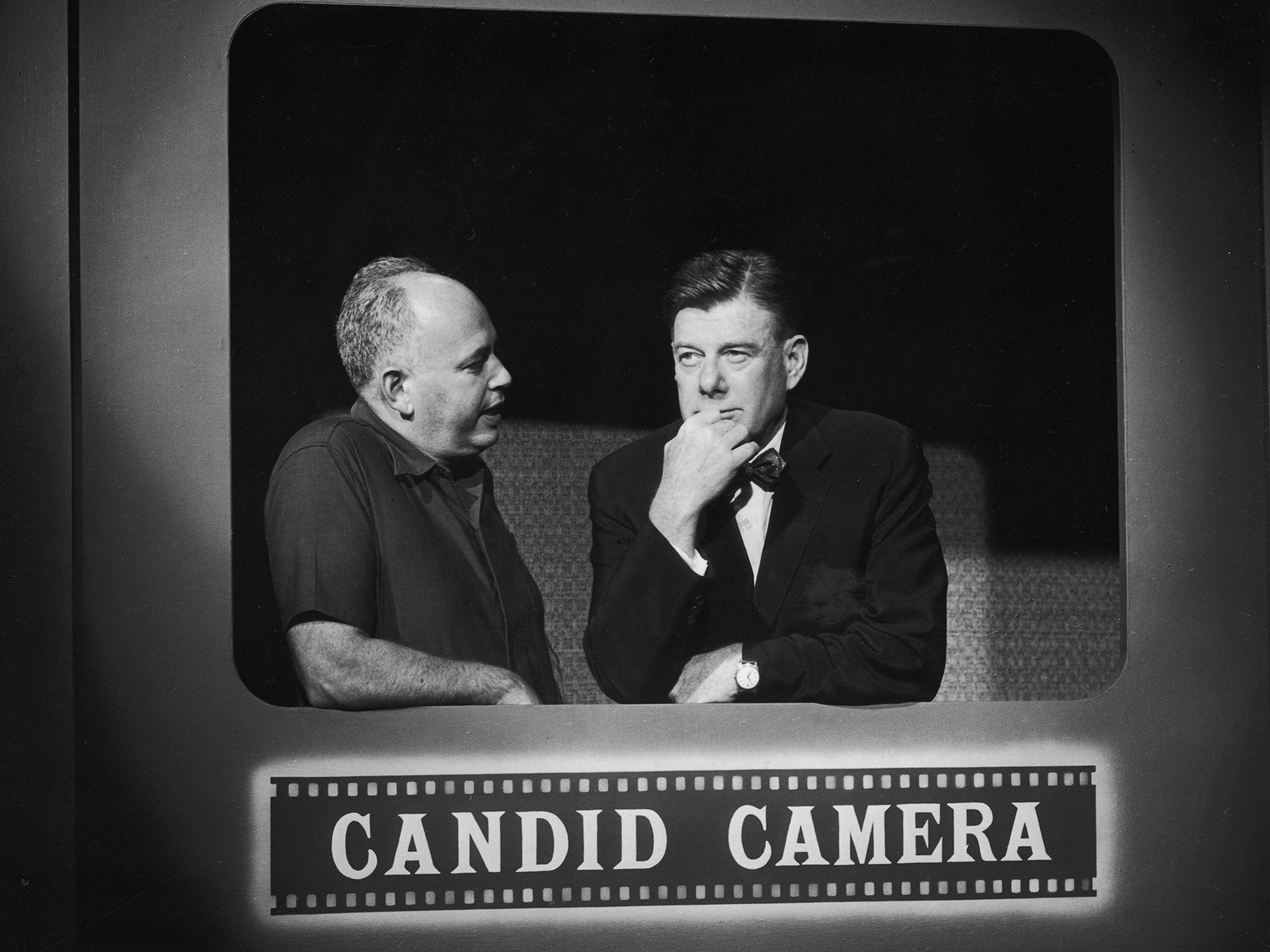 American entertainers Allen Funt, left, and Arthur Godfrey talk on the set of Candid Camera in 1961