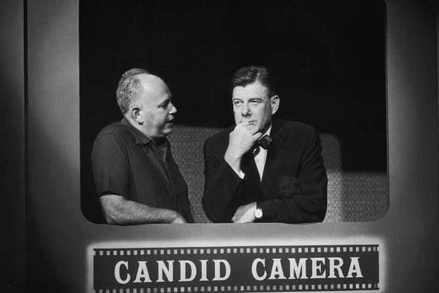 American entertainers Allen Funt, left, and Arthur Godfrey talk on the set of Candid Camera in 1961