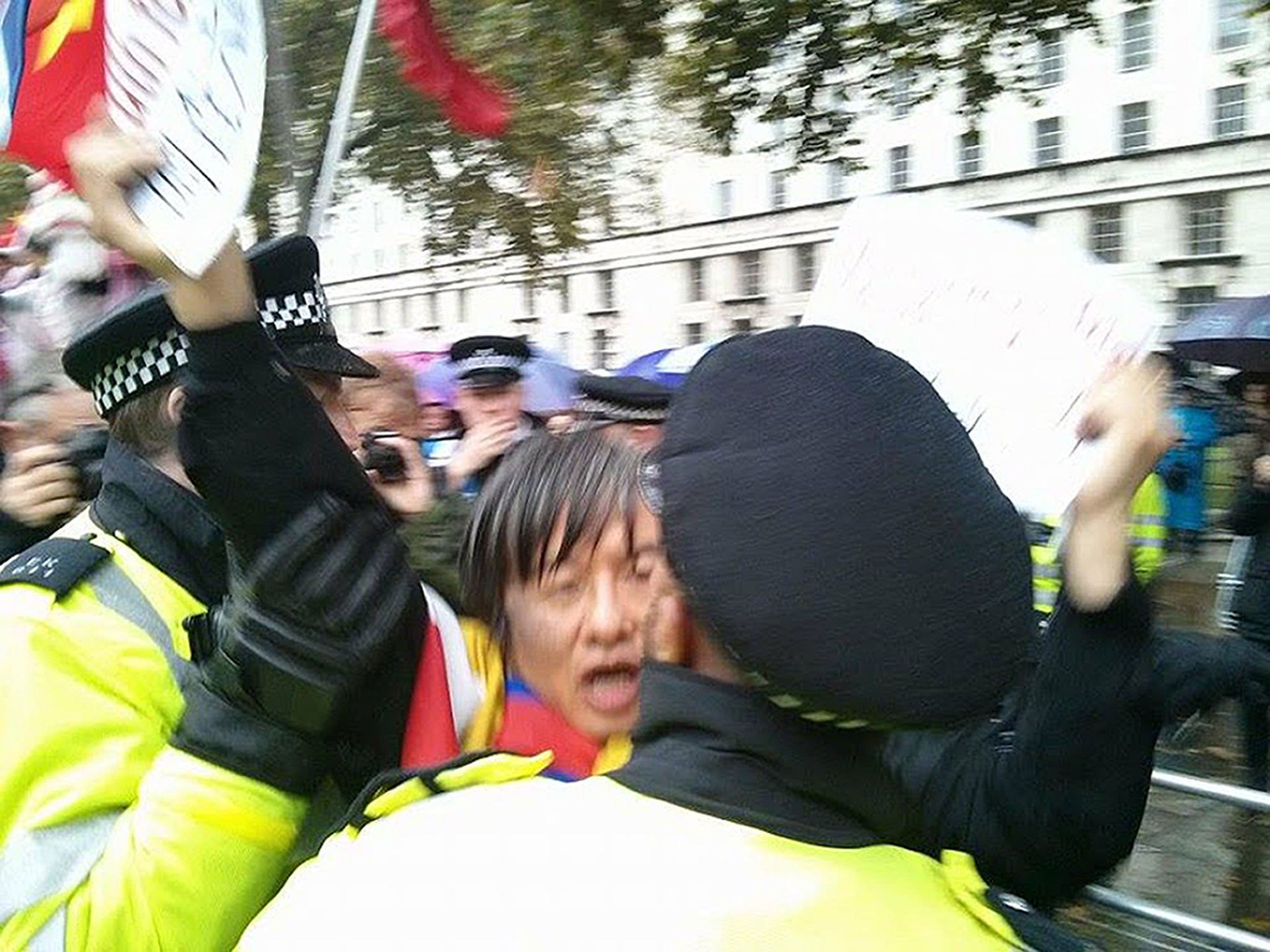 Chinese democracy activist and Tiananmen Square survivor Shao Jiang being led away by police officers. The police were accused of mishandling the 47-year-old away from a human rights protest before raiding his home