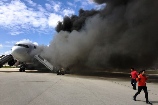 Thick plumes of black smoke were seen coming from the aircraft on the runway
