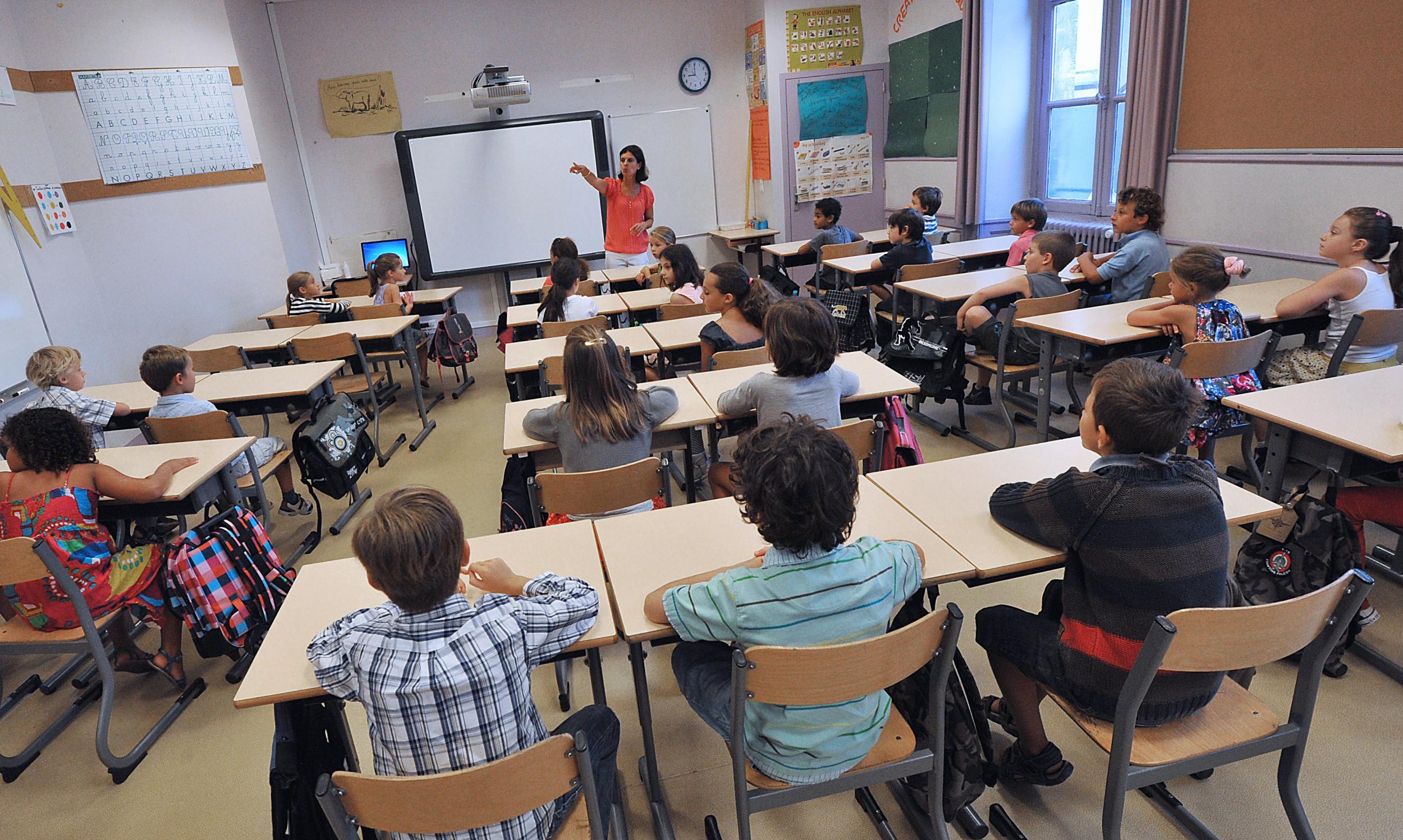 A teacher teaching in a classroom.