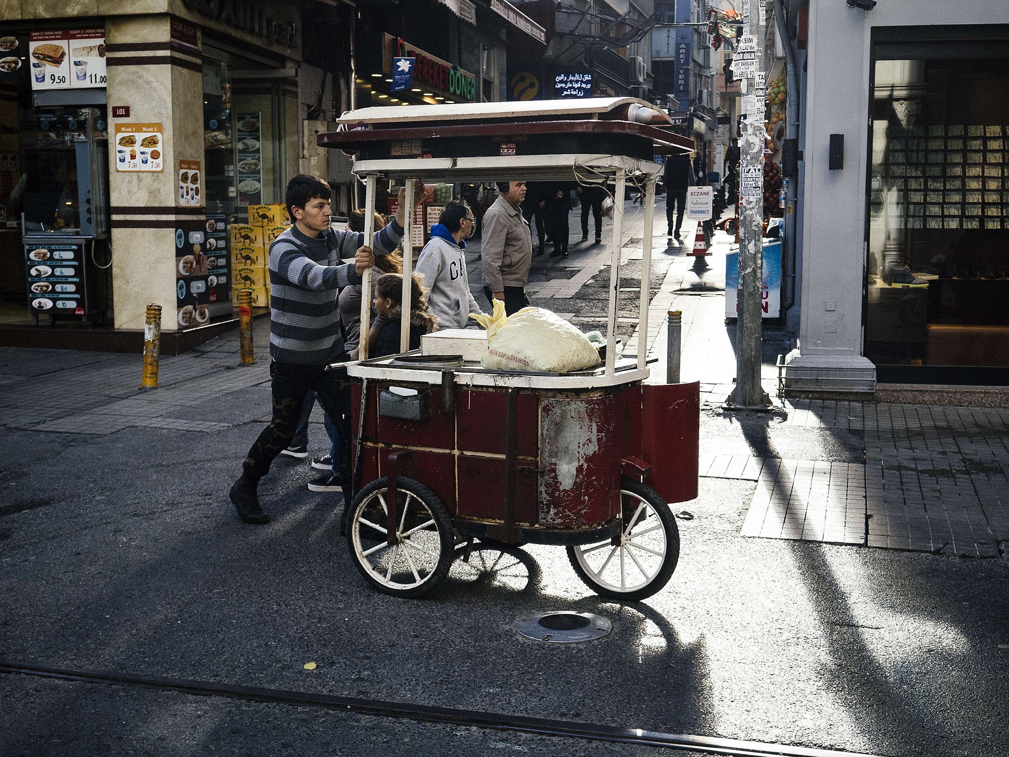 A pedler pushes his cart in downtown Istanbul on 28 October 2015