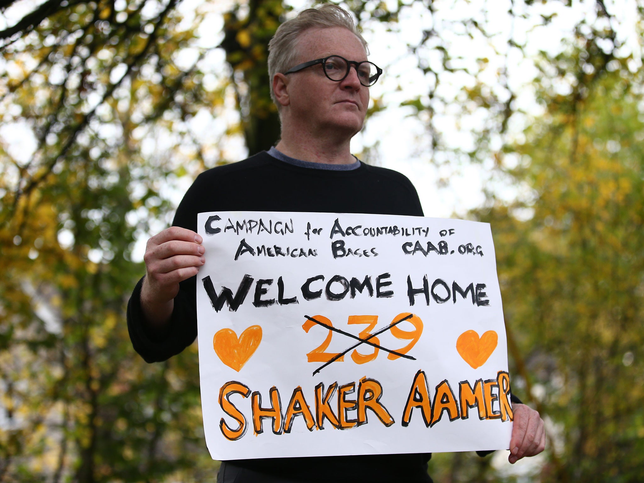 A campaigner at Biggin Hill Airport welcomes Shaker Aamer home
