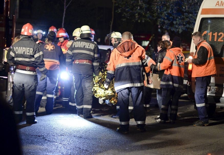 Emergency services respond to the disaster outside the Colectiv nightclub in Bucharest