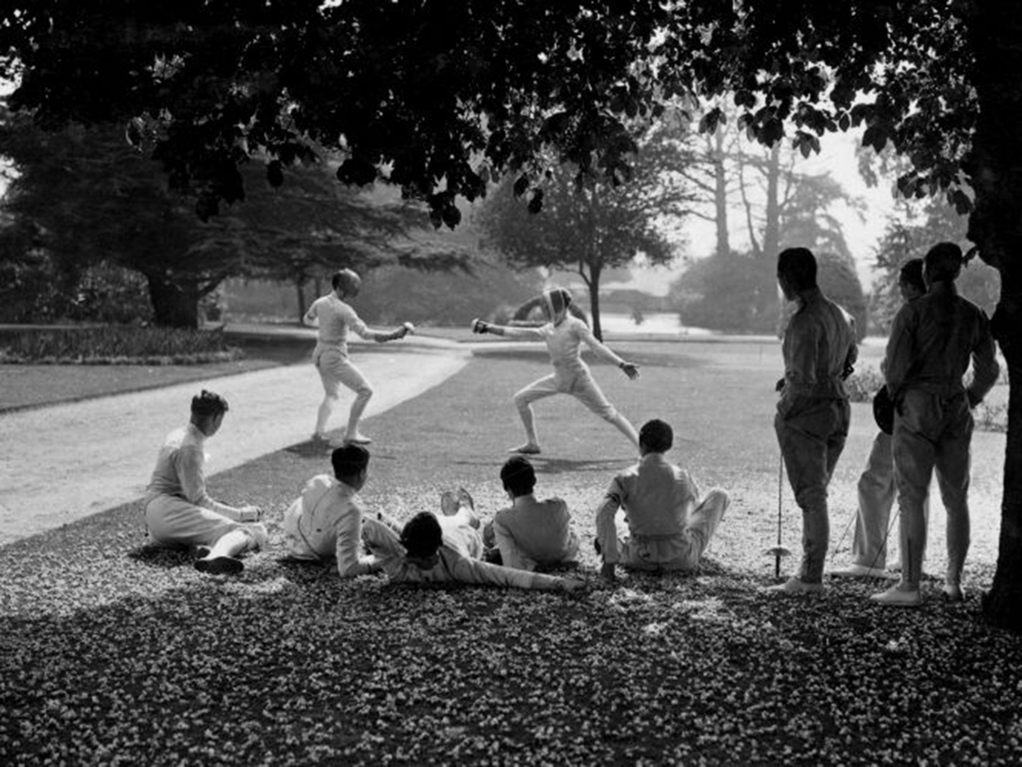 Cambridge and Oxford students hone their fencing skills back in 1936