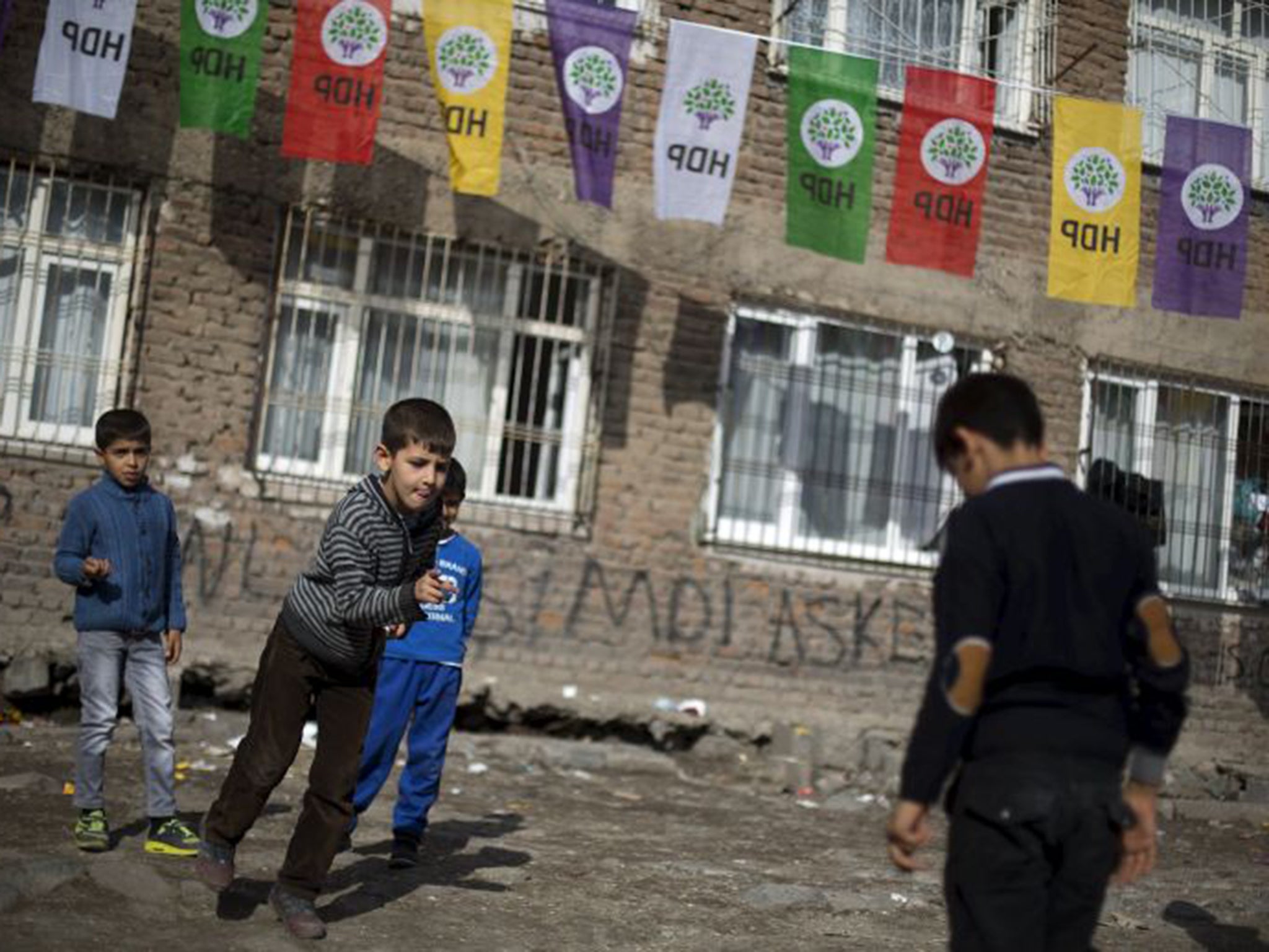 Children in Diyarbakir, in the south-east of Turkey, play under banners for the pro-Kurdish HDP
