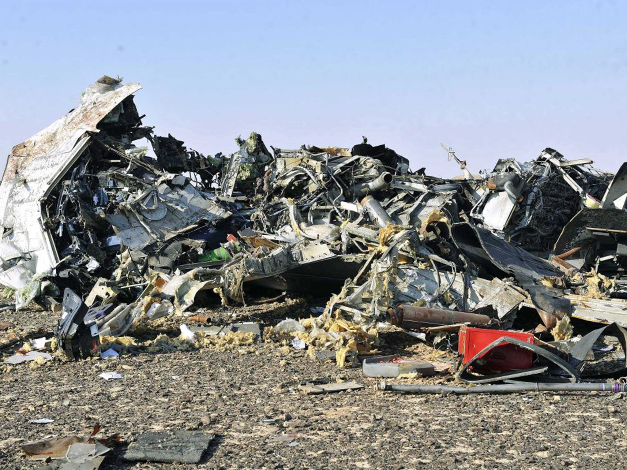 Debris lies strewn across the sand at the crash site