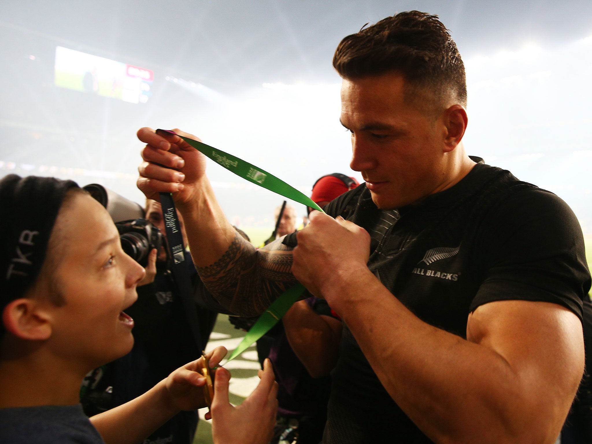 Sonny Bill Williams gives his Rugby World Cup medal to a young fan