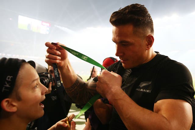 Sonny Bill Williams gives his Rugby World Cup medal to a young fan