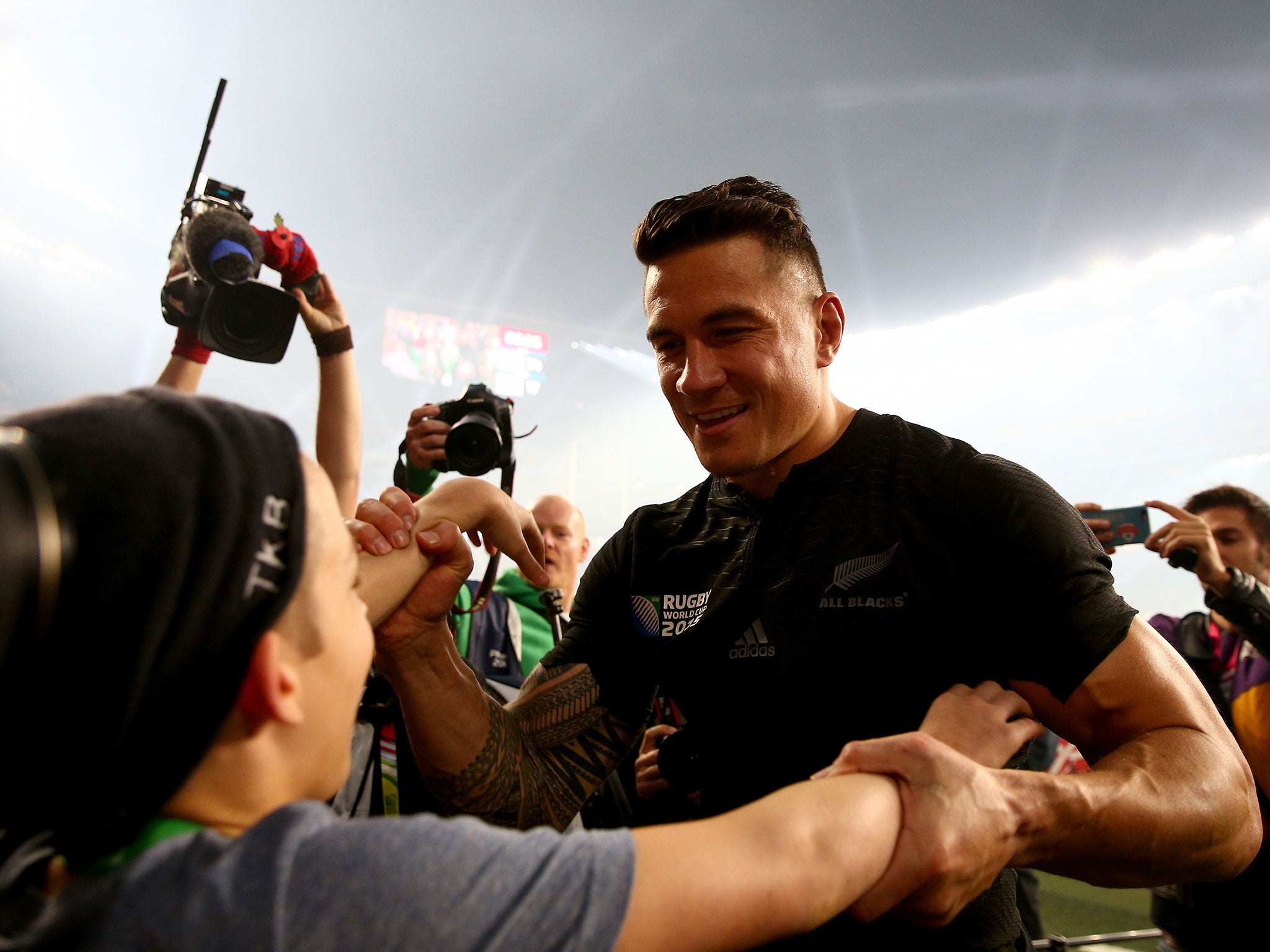 Sonny Bill Williams gives his Rugby World Cup winners' medal to a young fan