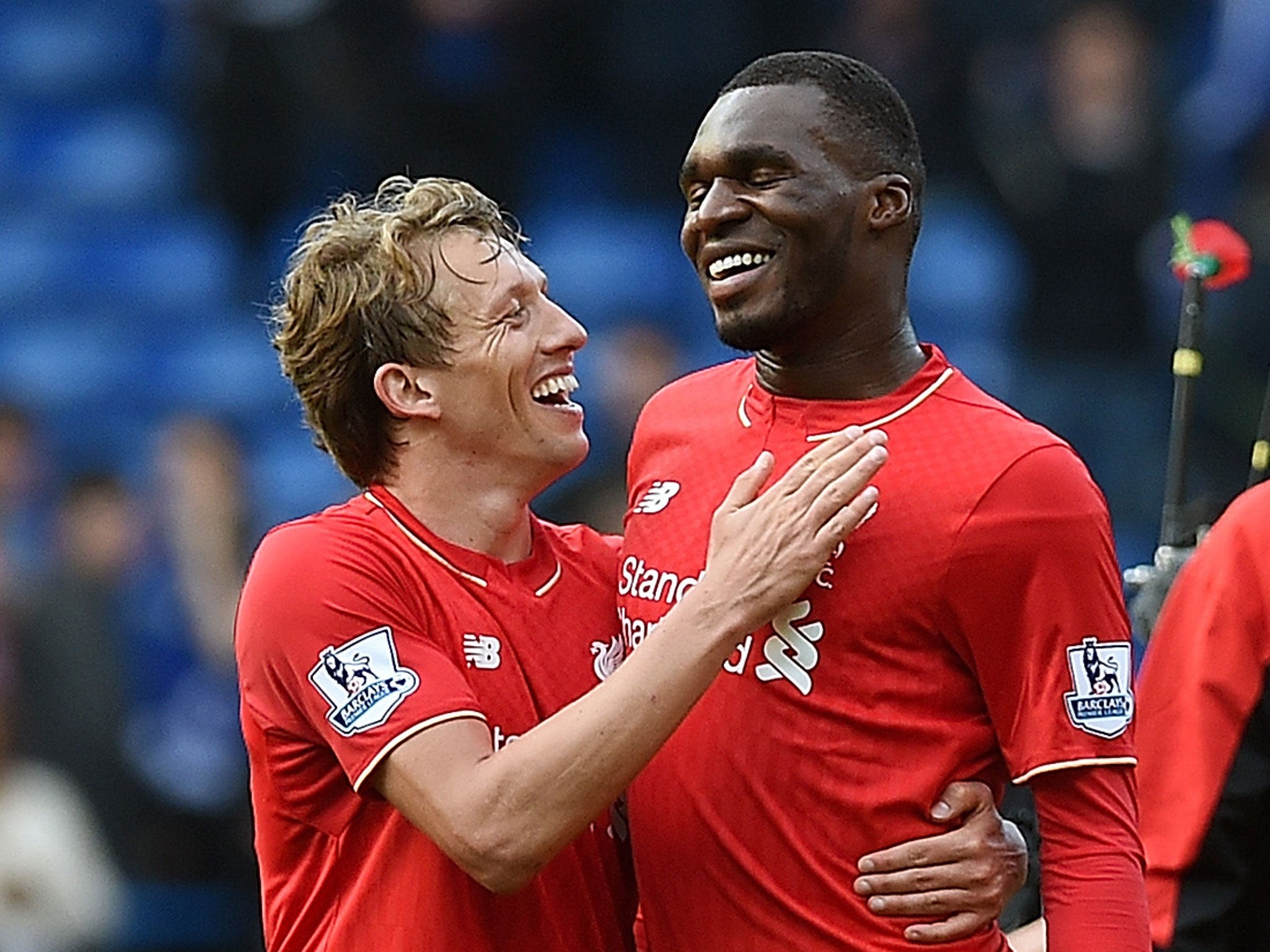 Lucas Leiva celebrates with Christian Benteke after Liverpool's win at Chelsea