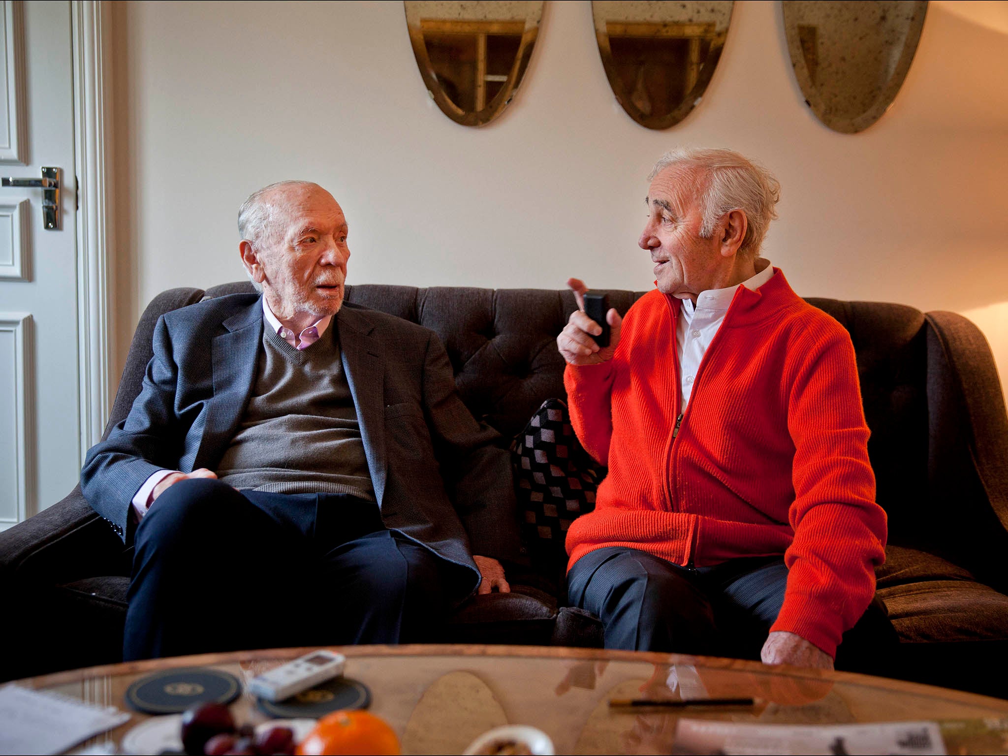 Charles Aznavour (red top) and Herbert Kretzmer, both in their 90s, meet at a London hotel.