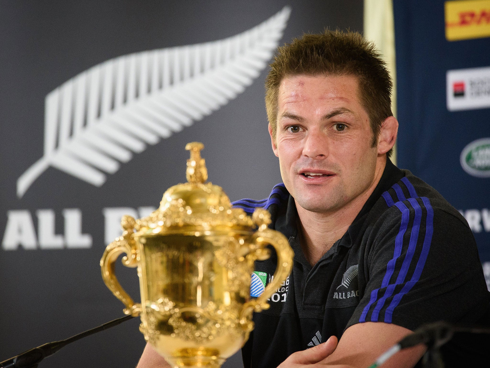 New Zealand captain Richie McCaw sits with the Webb Ellis Cup