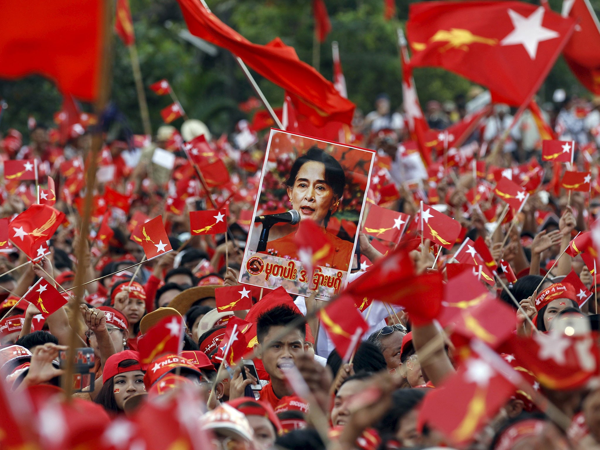 Supporters listen as Aung San Suu Kyi gives a speech in Yangon