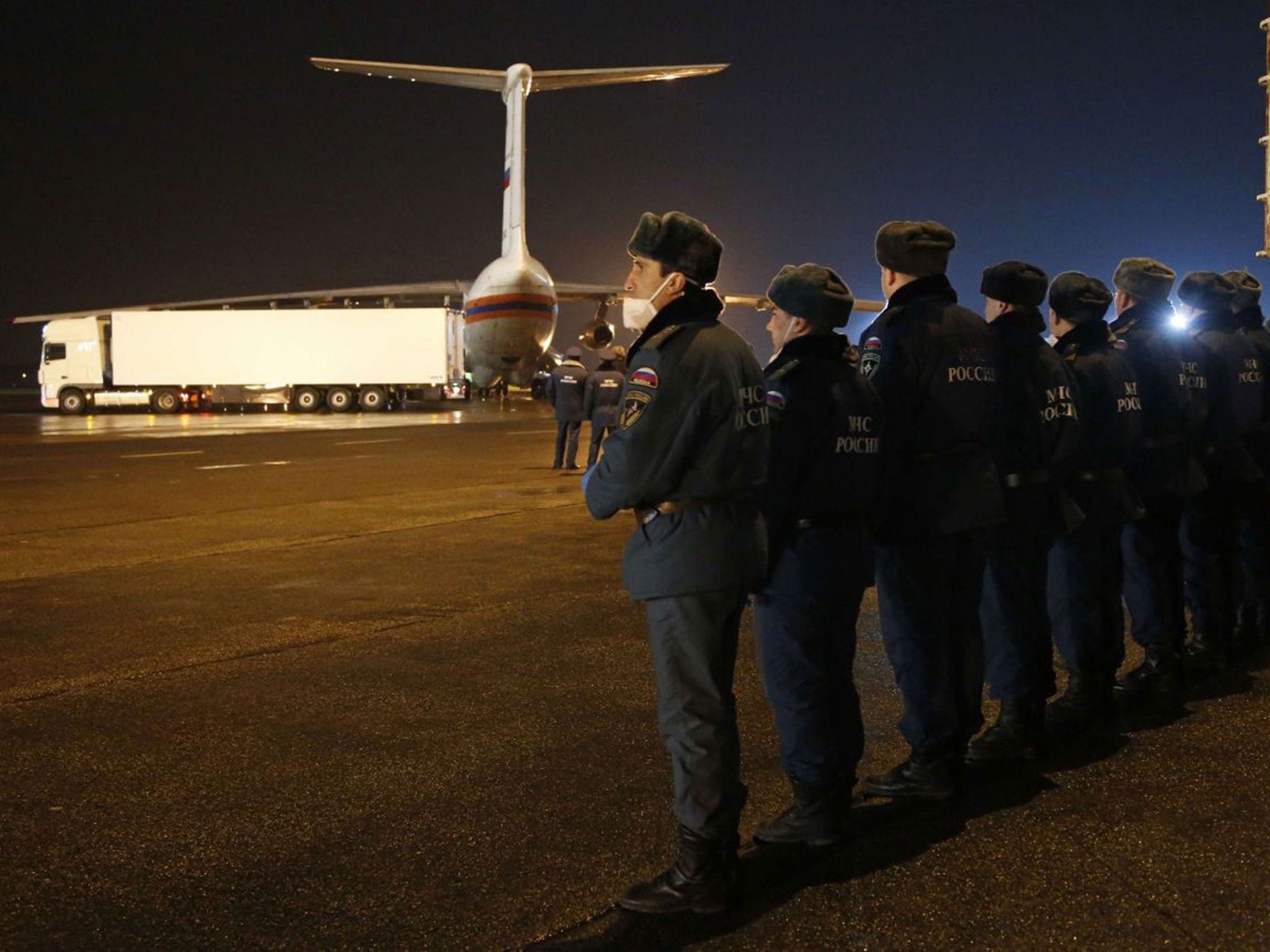 Russian Ministry for Emergency Situations employees prepare to load the bodies of the victims from the ministry's plane at the airport in St Petersburg on November 2, 2015.