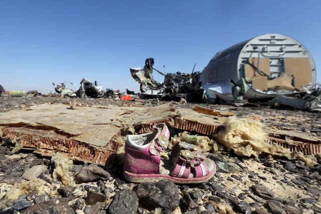 A child's shoe is seen in front of debris from a Russian airliner which crashed at the Hassana area in Arish city, north Egypt. Russia has grounded Airbus A321 jets flown by the Kogalymavia airline, Interfax news agency reported , after one of its fleet crashed in Egypt's Sinai Peninsula, killing all 224 people on board