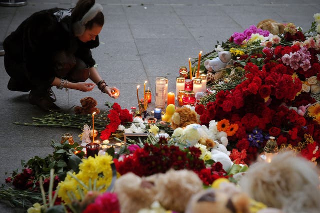 Russian people lay flowers and light candles to memory of victims at Pulkovo airport in St Petersburg