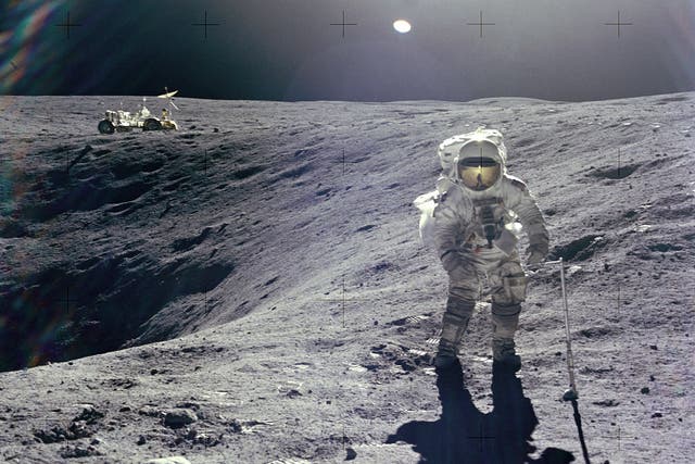 Astronaut Charles M. Duke Jr., Lunar Module pilot of the Apollo 16 mission, is photographed collecting lunar samples