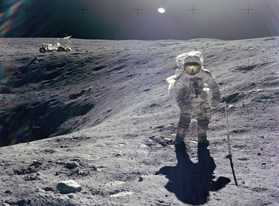 Astronaut Charles M. Duke Jr., Lunar Module pilot of the Apollo 16 mission, is photographed collecting lunar samples