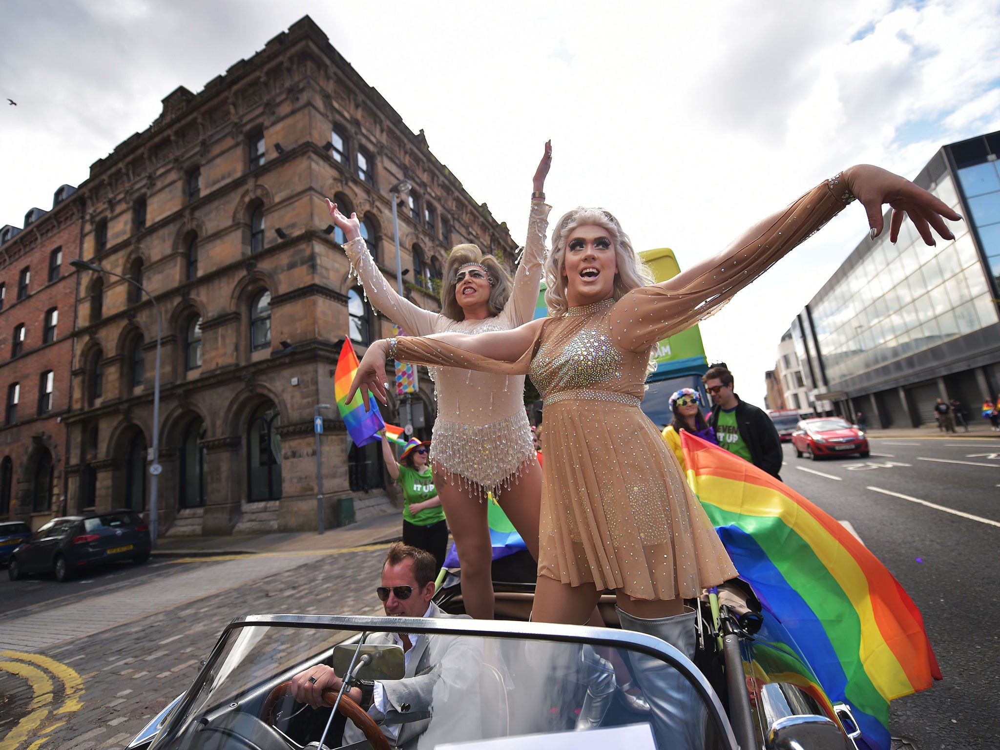 Drag queens wave to the crowds as thousands of participants and supporters take part in the 25th annual Belfast Pride parade on August 1, 2015
