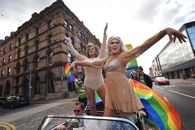 Drag queens wave to the crowds as thousands of participants and supporters take part in the 25th annual Belfast Pride parade on August 1, 2015
