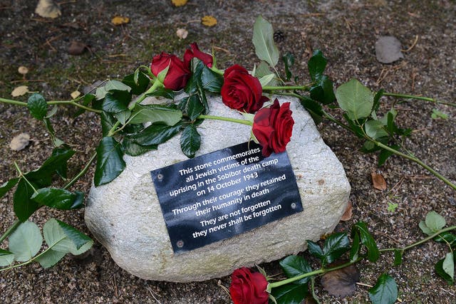 Flowers were laid in the woods next to the Sobibór World War II Nazi extermination camp on 14 October, 2013 to commemorate the 70th anniversary of an uprising in the camp