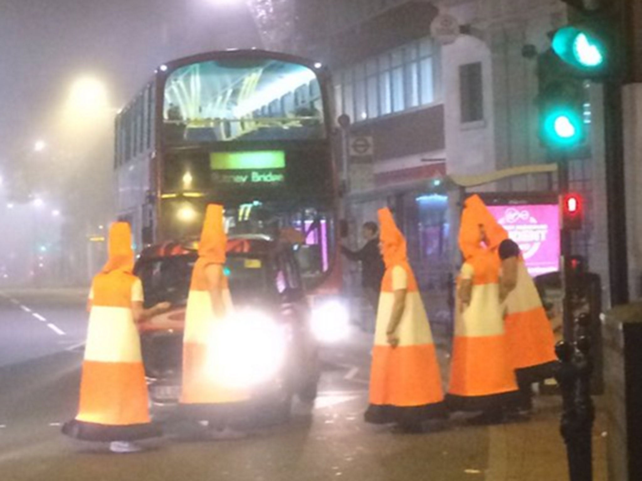 Men dressed as traffic cones block traffic in Clarence Street