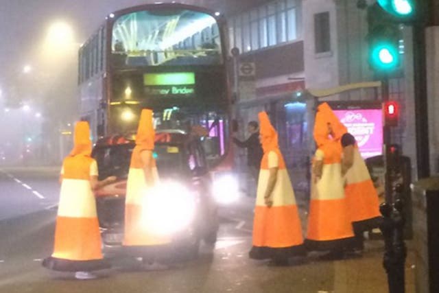 Men dressed as traffic cones block traffic in Clarence Street