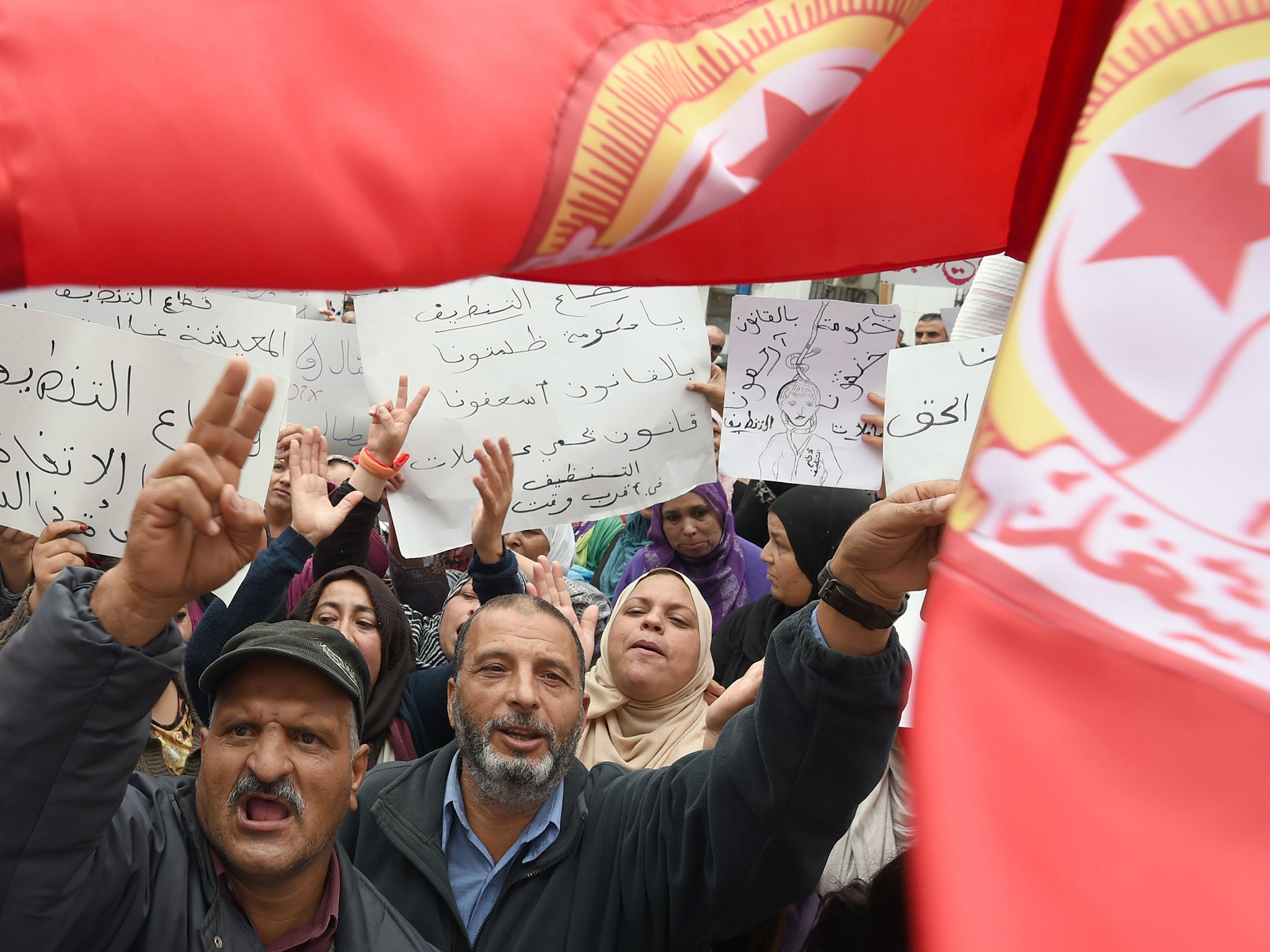 Tunisian demonstrators stage a sit-in in front of the headquarters of the Tunisian General Labour Union office in Tunis on 31 October. They are demanding an increase in the wages of private sector workers