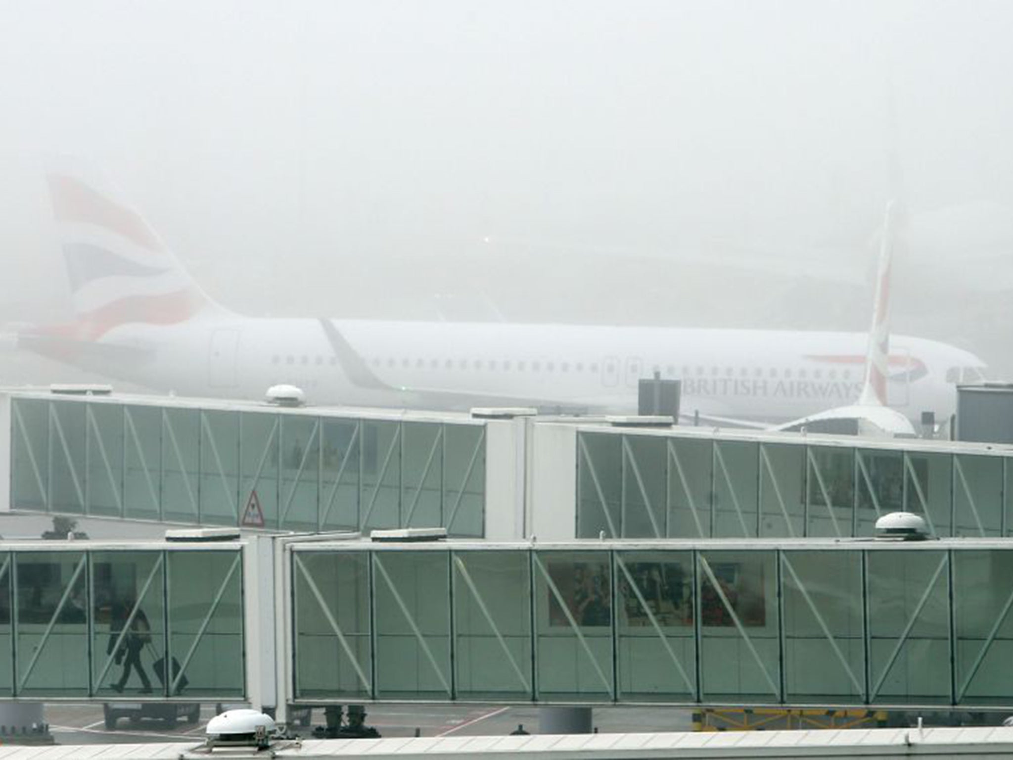 A British Airways plane at Terminal 5 Heathrow, as thick fog disrupted flights at UK airports for a second day
