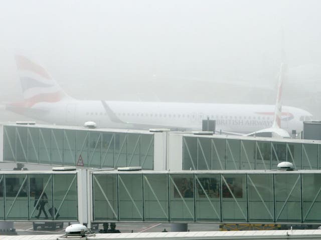 A British Airways plane at Terminal 5 Heathrow, as thick fog disrupted flights at UK airports for a second day
