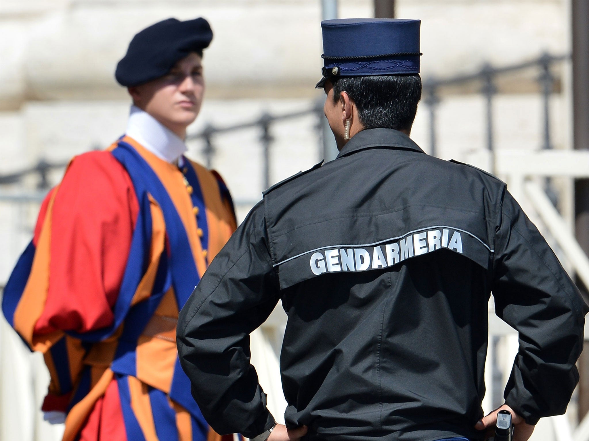 A Vatican's gendarme, right, with a member of the Swiss Guard, one of the Pope's personal bodyguards