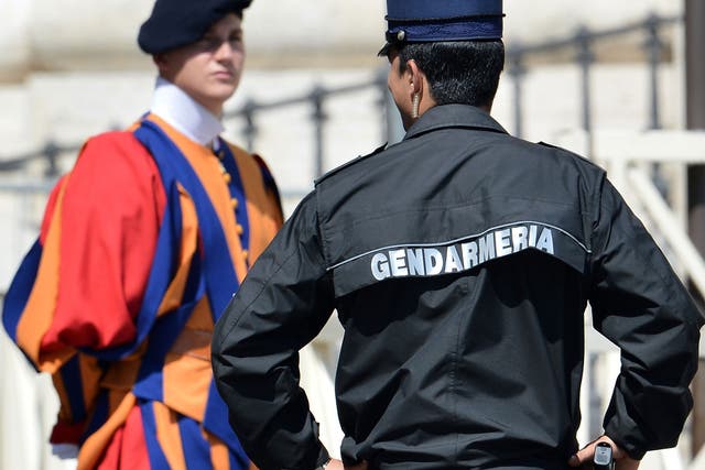 A Vatican's gendarme, right, with a member of the Swiss Guard, one of the Pope's personal bodyguards