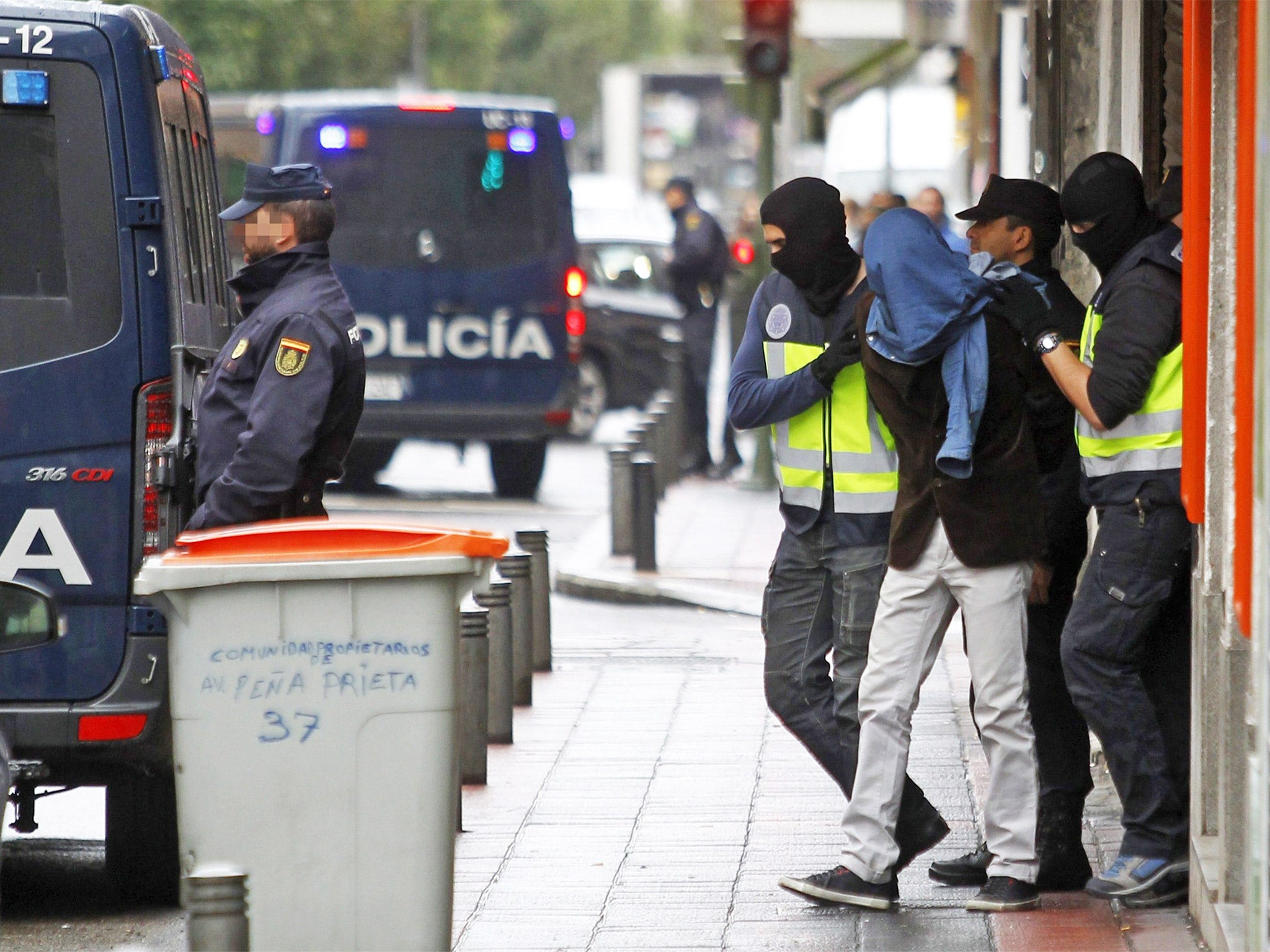 Police arrest one of the men accused of having links to Isis, in Madrid on Tuesday