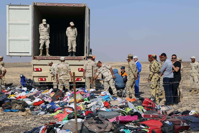 Russian emergency services personnel and Egyptian servicemen working at the crash site of a A321 Russian airliner in Wadi al-Zolomat, a mountainous area of Egypt's Sinai Peninsula