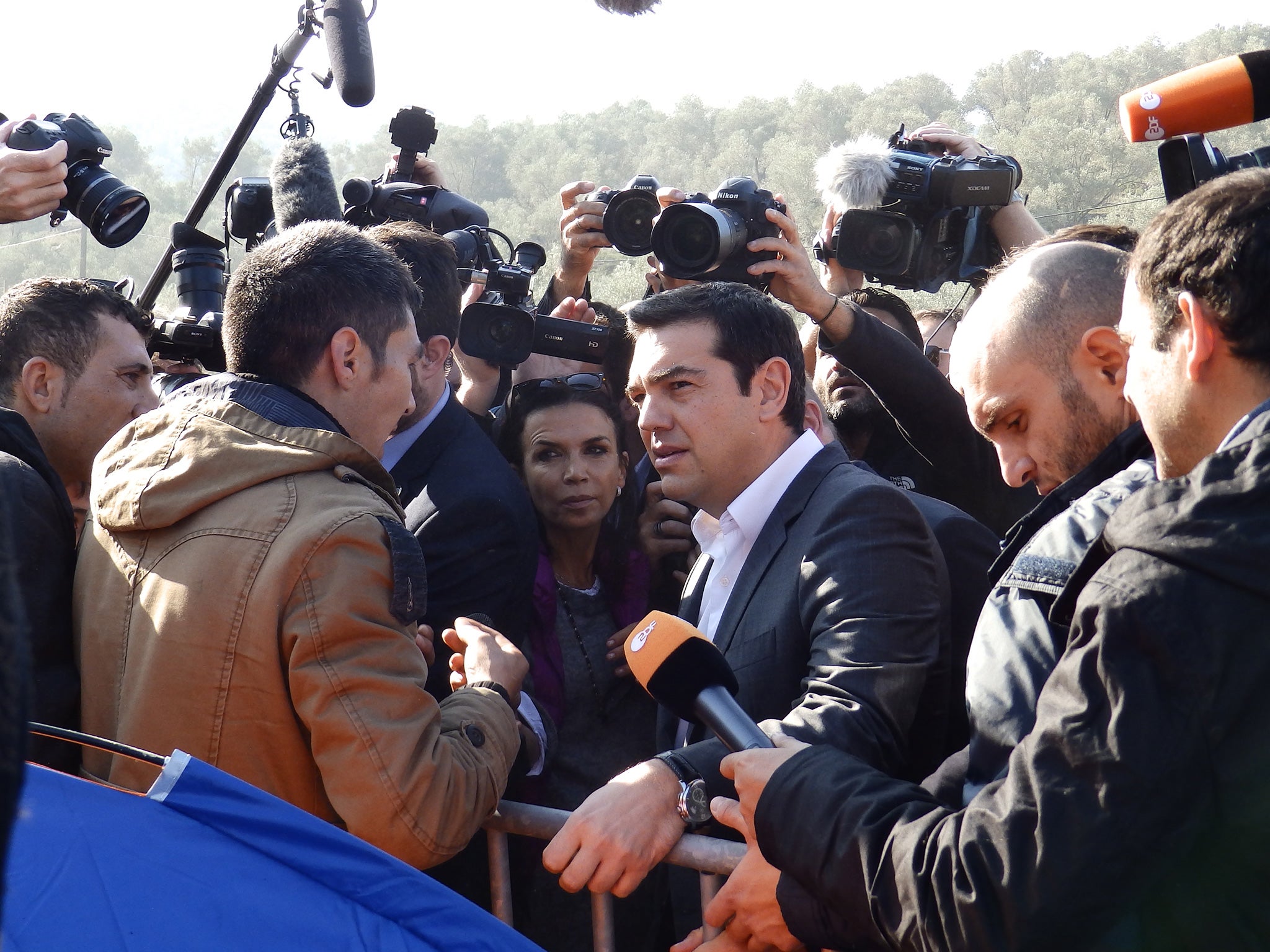 Alexis Tsipras is questioned by an asylum seeker during his tour of the Moria camp