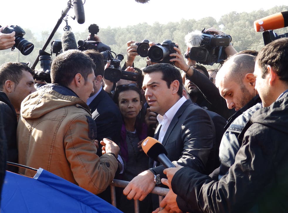 Alexis Tsipras is questioned by an asylum seeker during his tour of the Moria camp