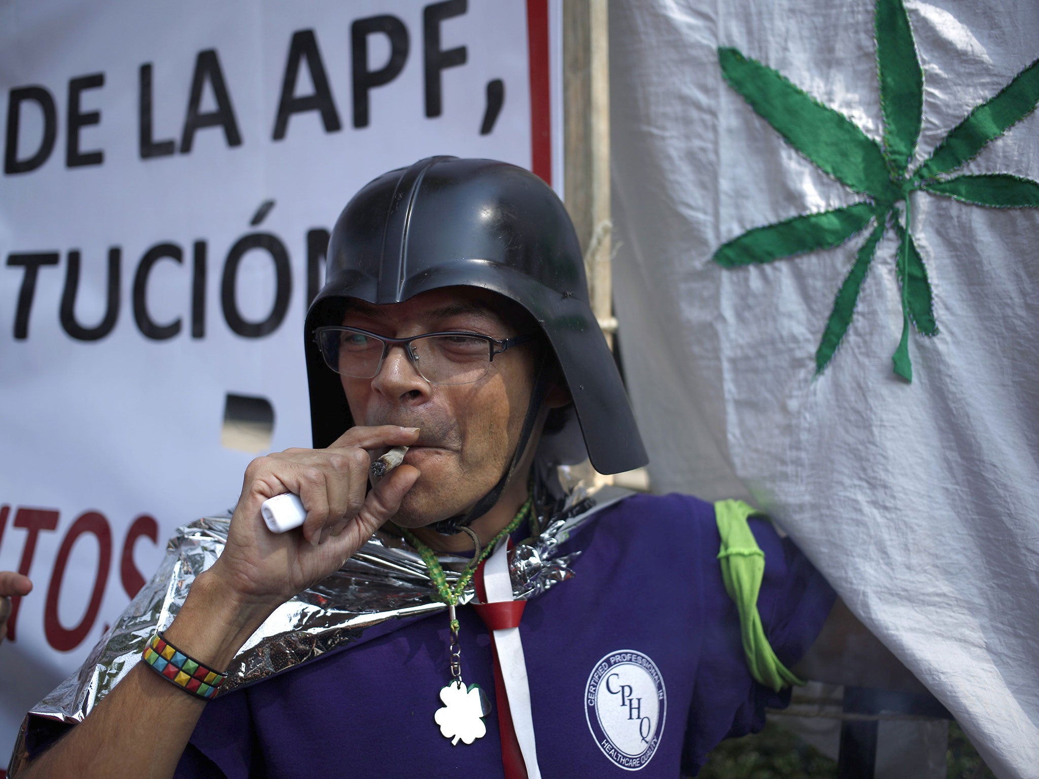 A supporter of the legalisation of marijuana smokes outside the Supreme Court in Mexico City after the historic ruling. But the country’s battle against drug cartels is set to continue