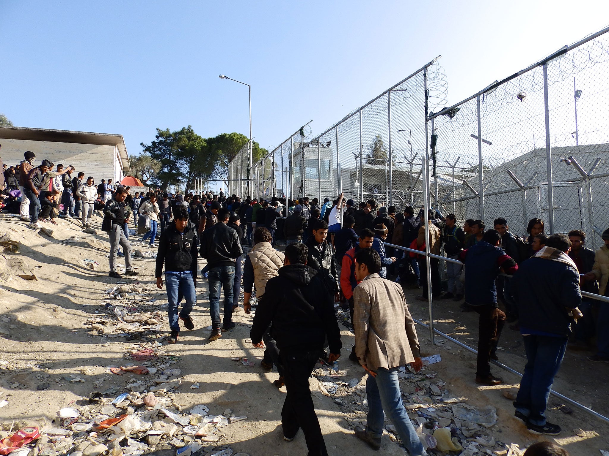 Asylum seekers queue to register at the Moria refugee camp in Lesbos, as numbers rose rapidly because of a backlog caused by a ferry strike trapping migrants on the island