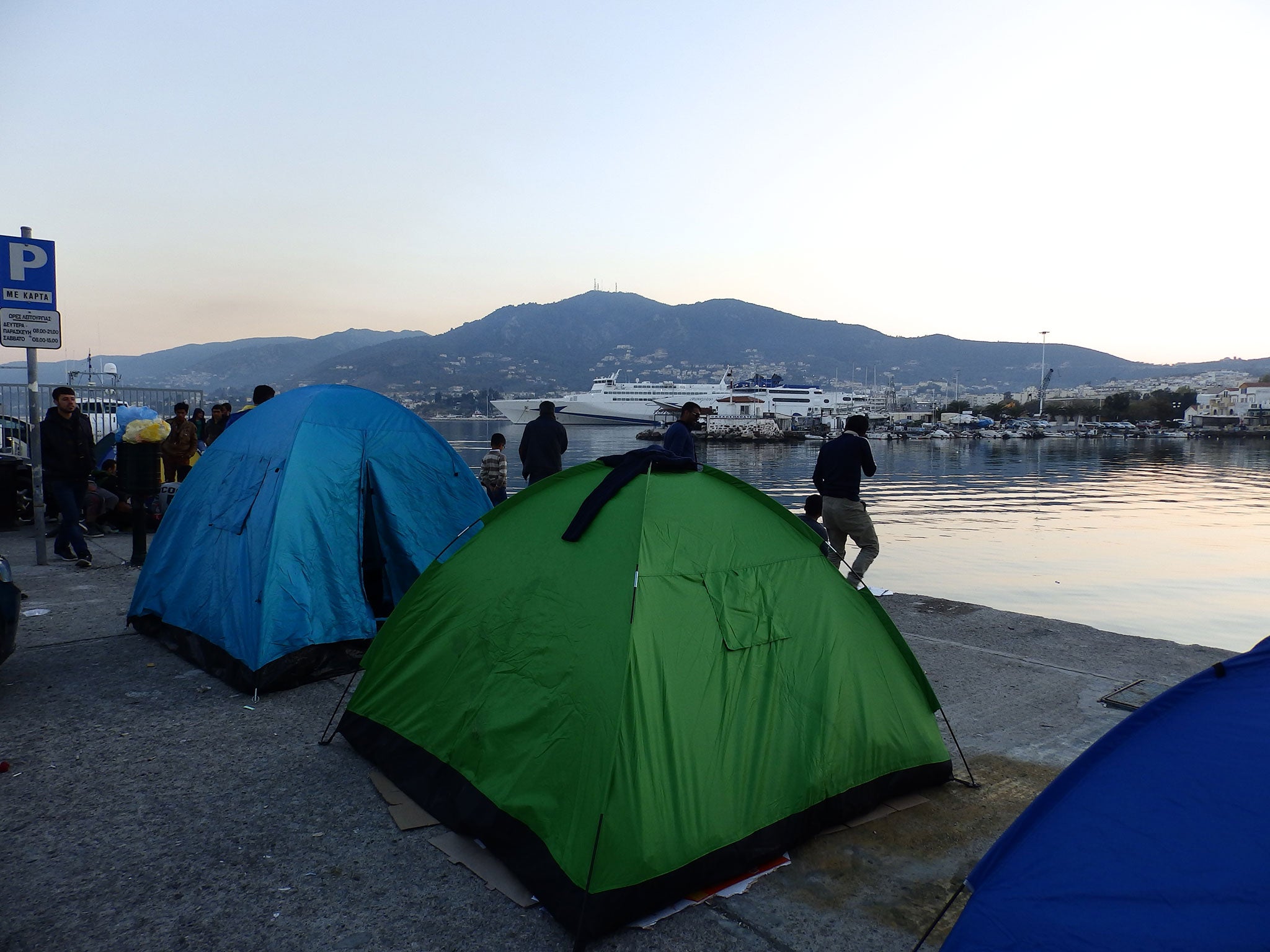 Asylum seekers preparing to spend the night next to the port at Mytilene, where a ferry strike has prevented thousands of refugees leaving Lesbos for four days