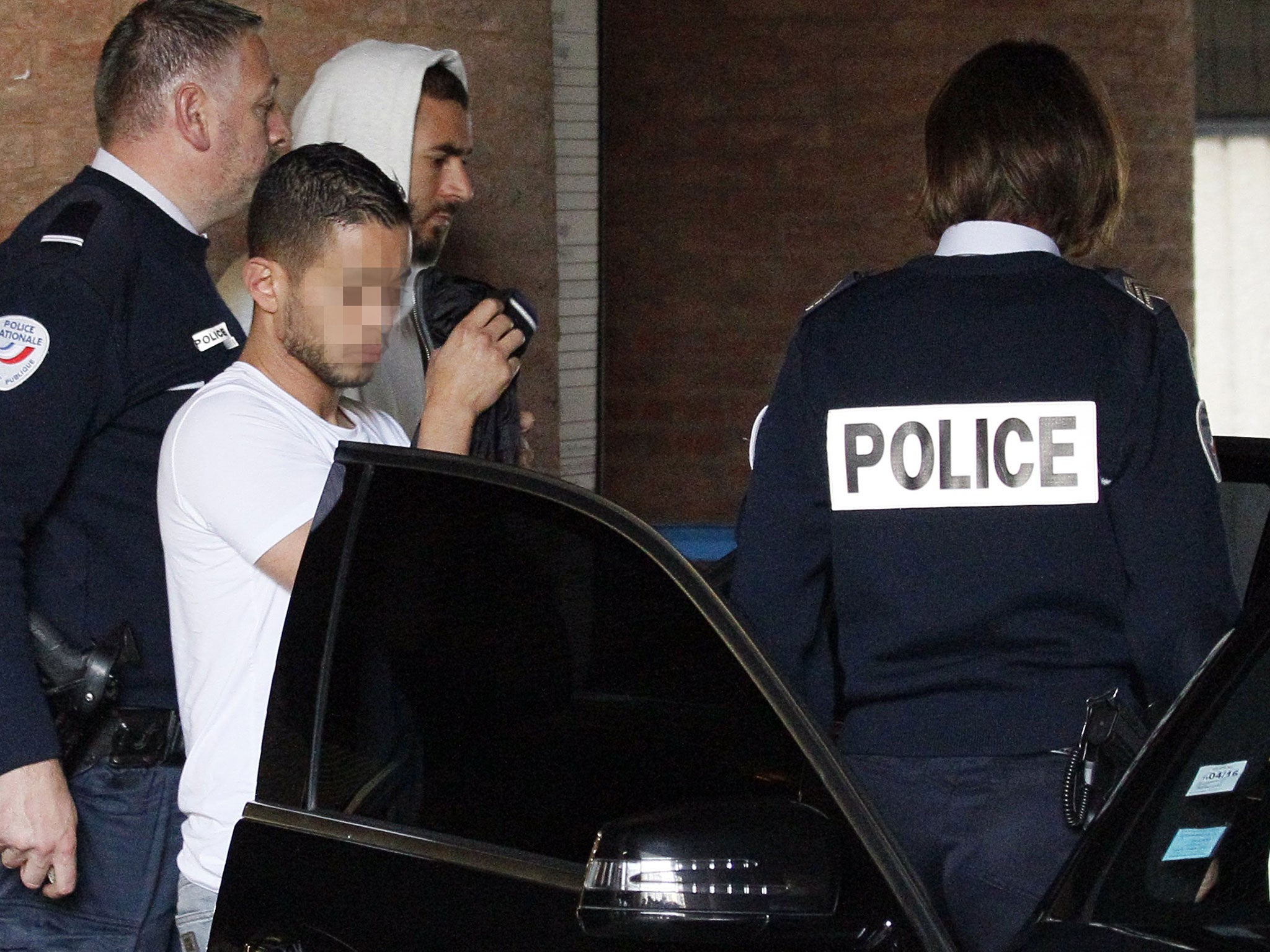 Real Madrid’s French striker Karim Benzema, second right, leaves the court house in Versailles